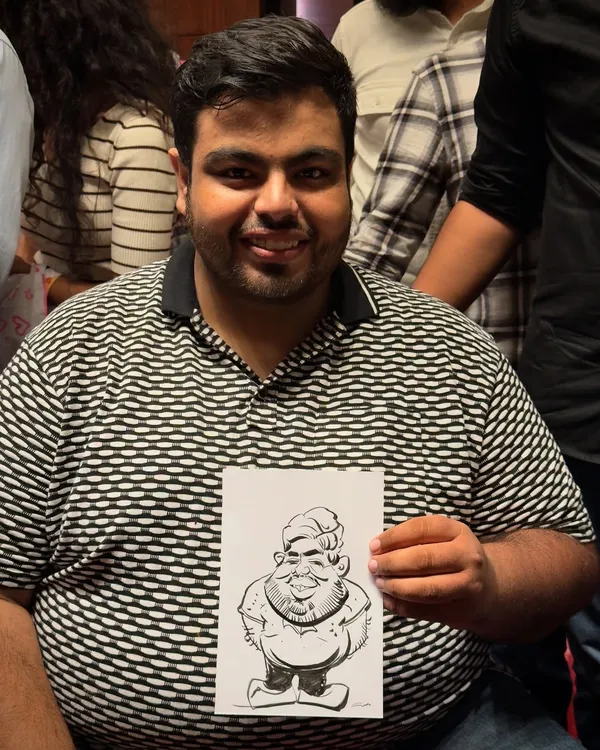 Big smiles, bigger heads. That’s the magic of caricature. This happy guest is holding his fun, personalized souvenir.