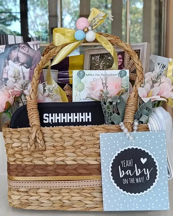 A perfect hamper to pamper a 'Mom To Be'. This basket is filled with goodies for both mom and baby, including an eye mask, photos of the parents, and a 'Baby on the Way' card.