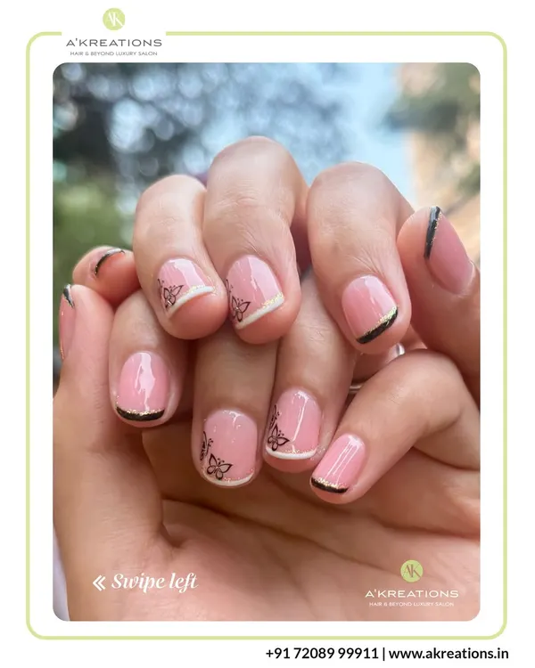 A modern take on the French manicure, this design combines a classic pink base with delicate butterfly decals and fine black and white tip lines.