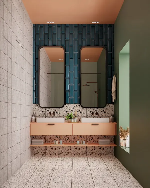 A full view of our playful and polished bathroom design. The combination of soft peach cabinetry, deep blue vertical tiles, and terrazzo flooring creates a space that is full of personality and style.