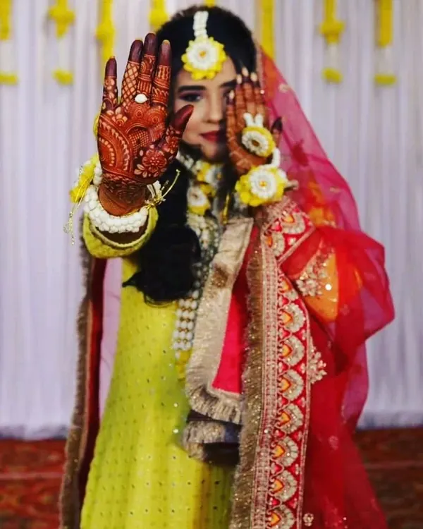 One of my pretty brides showing off her fresh henna stain during her haldi ceremony. The color looks so beautiful with her floral jewelry and yellow outfit.