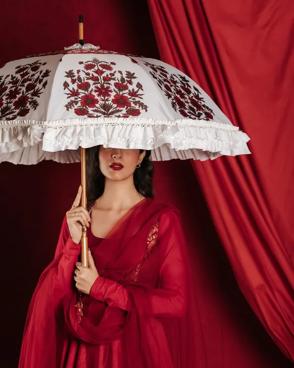 I created this shot for a designer umbrella collection, using a bold red backdrop to make the product's intricate white embroidery pop. My focus here was on creating a high contrast, editorial look that feels both elegant and modern, perfect for a brand's hero image.