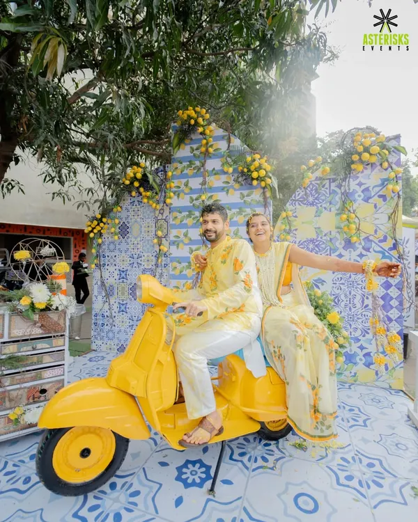 A picture-perfect Haldi moment with our Mediterranean-themed decor, complete with a vintage scooter and lemon-adorned backdrops. It's all about creating fun, Instagrammable spots.