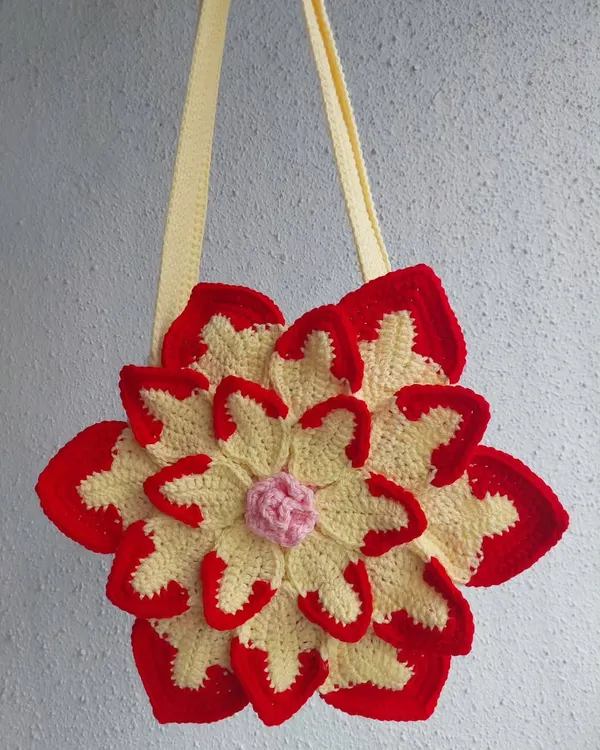 A clean, simple shot of the Lotus Bag, highlighting its intricate, layered petal design in red, yellow, and pink.