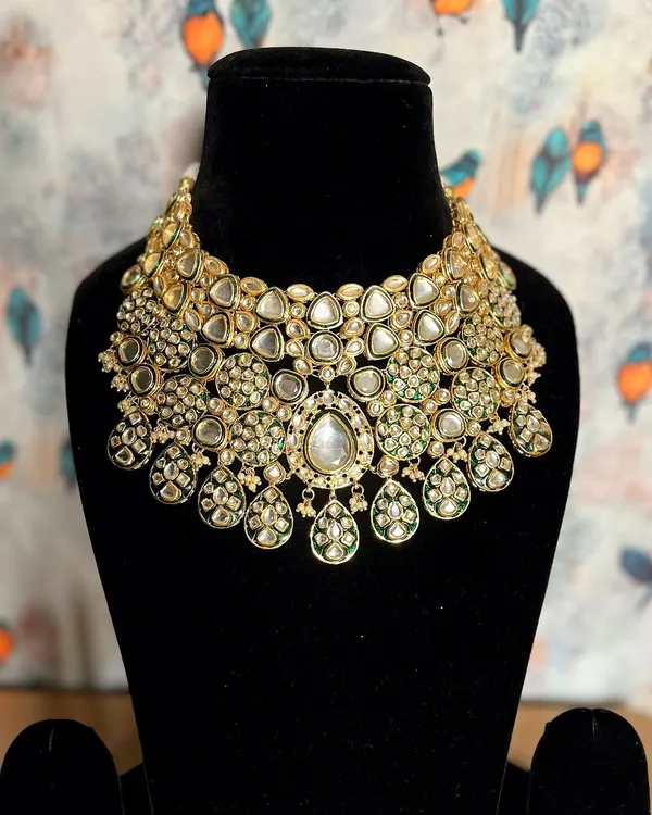 This royal extravagant Kundan jewelry piece is designed to be the centerpiece of your bridal look. Its intricate design and grand scale ensure a breathtaking appearance.