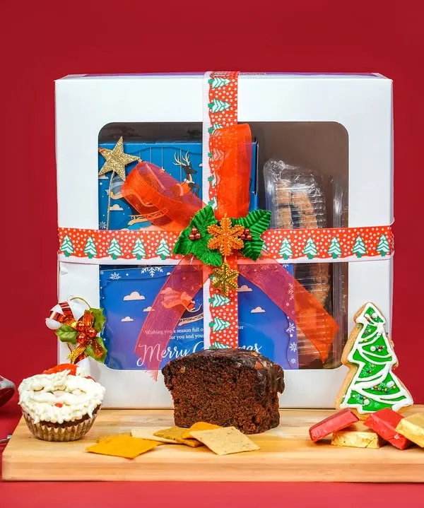 Our 'Snowflake' Christmas hamper is the ultimate festive gift, beautifully packaged and filled with a delightful assortment of our best holiday treats. It includes our signature premium plum cake, frosted muffins, chocolate chikki, and more, making it a perfect all-in-one present for family, friends, or corporate clients.
