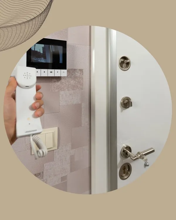 A resident uses a video door phone to see and speak with someone at the entrance. This IP-based system provides enhanced security for apartments and buildings by allowing remote verification of visitors.