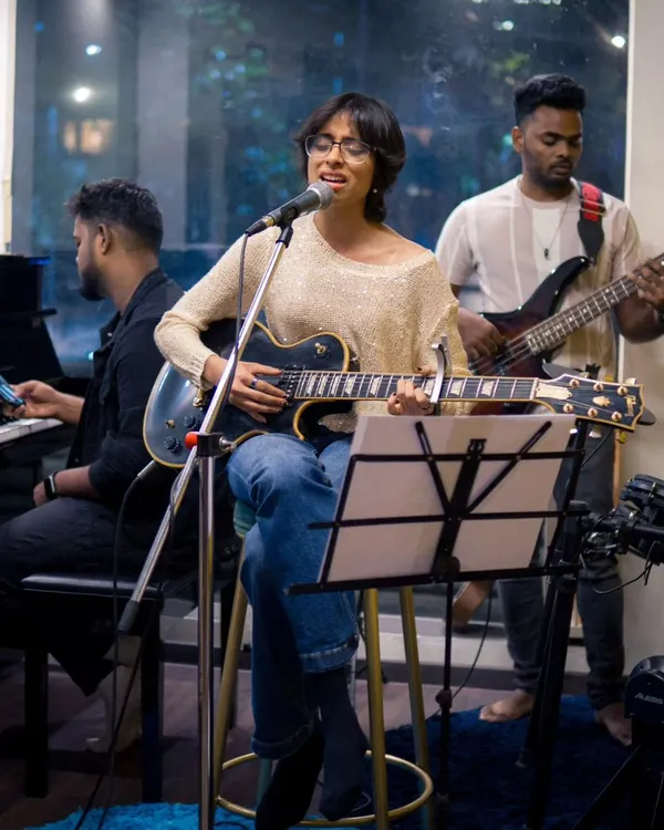 A full band setup during our artist showcase, featuring Anushka on vocals and guitar. Our space is equipped to handle everything from a solo act to a complete band with professional sound.