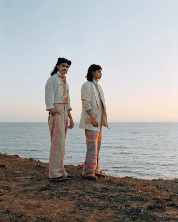 A wide shot from a menswear editorial on the coast. I chose this location for its dramatic cliffs and soft sunset light, creating a romantic and expansive backdrop for the collection.