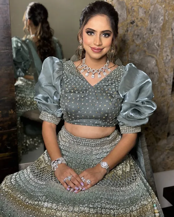 Sangeet glam goals. This bride-to-be is serving soft glam with a hint of sparkle in her stunning grey lehenga with dramatic puff sleeves.