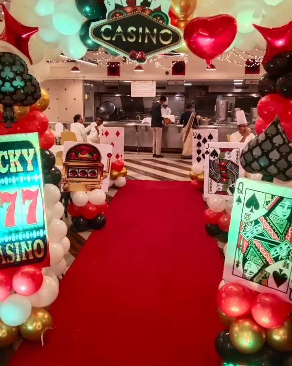 We create immersive experiences for corporate parties, like this grand casino night entrance. A red carpet, custom signage, and themed balloon arrangements set the stage for a memorable event from the moment guests arrive.