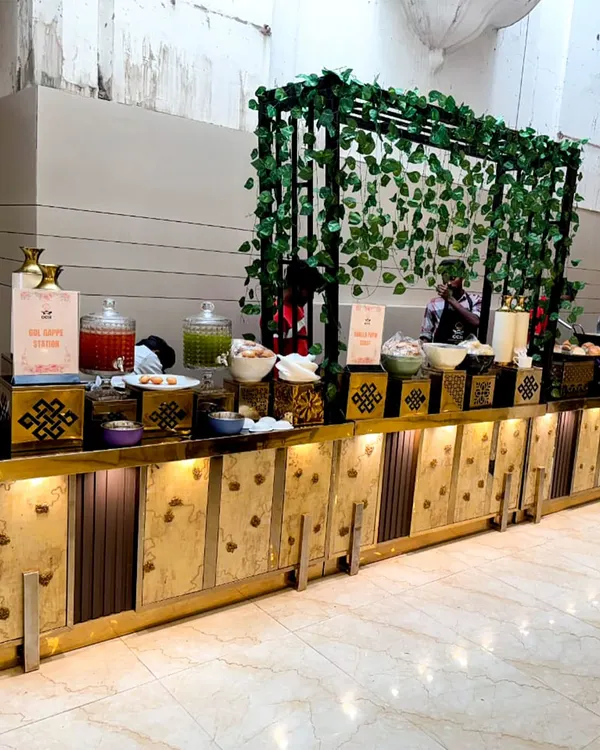 Good food, great setup, and warm vibes all around. This is a look at one of our beautiful buffet counters, complete with decorative elements and a refreshing drinks station.
