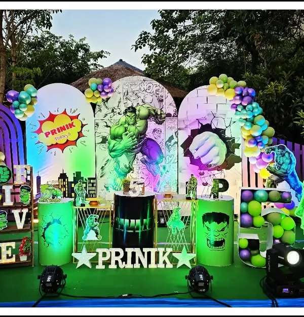 Hulk smash! This incredible Hulk-themed party for Prinik's 5th birthday is one of my most elaborate setups. It features dynamic lighting, multiple backdrops with comic book art, and several Hulk cutouts to create a truly powerful and immersive experience.