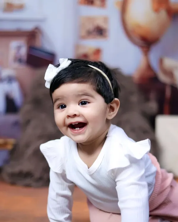 The pure joy of a baby on the move. This crawling shot captures a happy and curious expression during a sitter session.