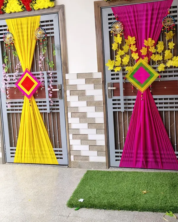 This is a popular choice for home-based wedding functions. I use bright, contrasting fabric drapes in colors like yellow and magenta to create a festive entrance, perfect for setting the mood for a Haldi or Mehendi ceremony.