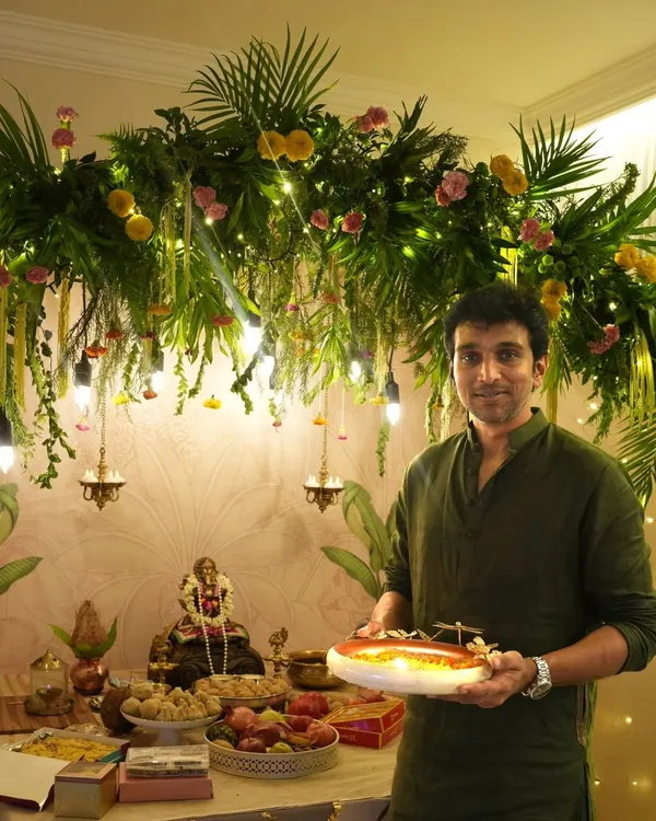 We were honored to create this Ganpati celebration space for actor Pratik Gandhi. The decor features a stunning overhead installation of dense greenery, florals, and hanging lights, providing a beautiful and blessed setting for the festivities.