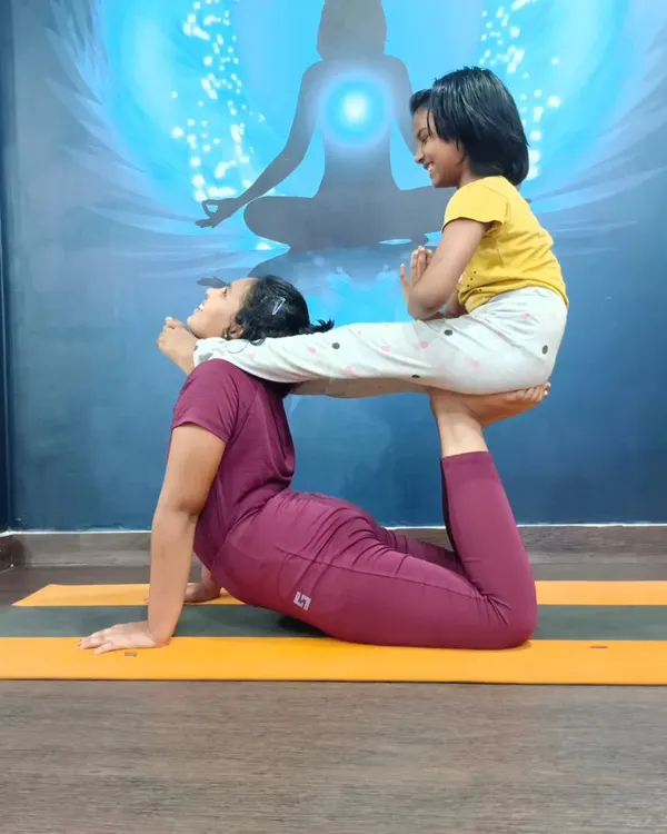 This is what pure joy in yoga looks like. Here, we're exploring a fun partner pose, which helps build trust and balance while sharing a good laugh. It’s a wonderful way for kids to connect.