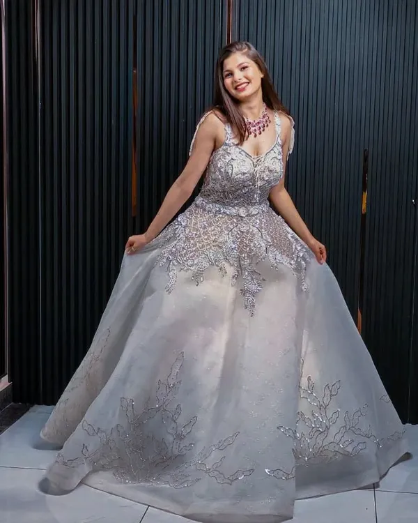 This stunning silver ball gown is perfect for a reception or engagement party. The intricate silver embroidery and voluminous skirt create a look of pure glamour, ensuring you feel like royalty.