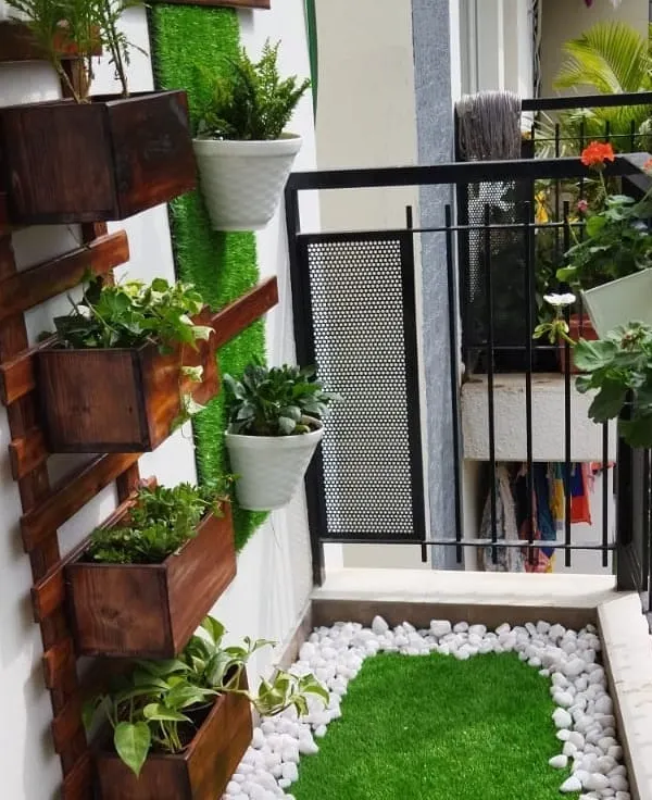 We designed this beautiful and functional vertical garden for a client's balcony, creating a green oasis in the city. This setup uses a combination of wooden planters and wall-mounted pots to maximize space and visual impact.