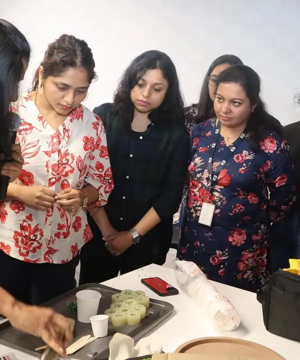 An instructor demonstrates the finer points of candle making to an attentive group during a corporate workshop at HBC, Bangalore. We provide close guidance to ensure everyone understands the process.