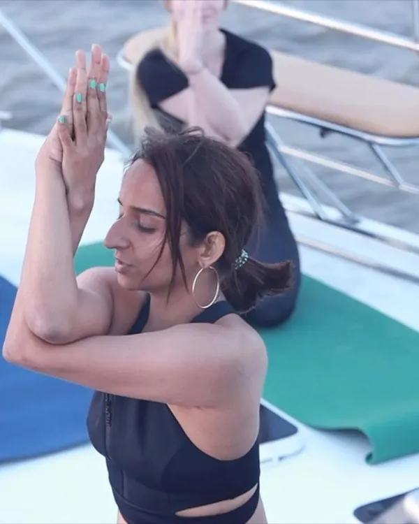 A moment of quiet focus in Garudasana (Eagle Pose) arms during our 'Yoga on the Sea' event. The salty air and gentle rock of the boat added a new dimension to the practice.