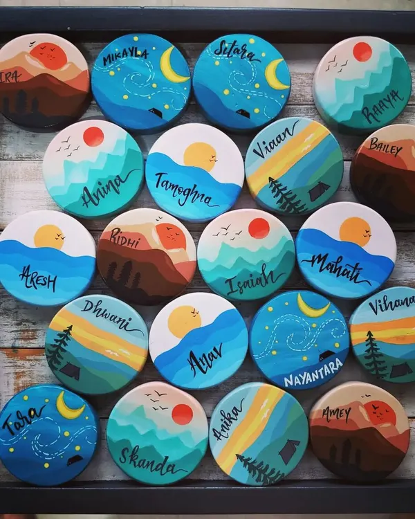 A full tray of our custom travel-themed magnets, created as birthday return gifts. Each one is a tiny, hand-painted world, from starry nights to mountain sunrises.