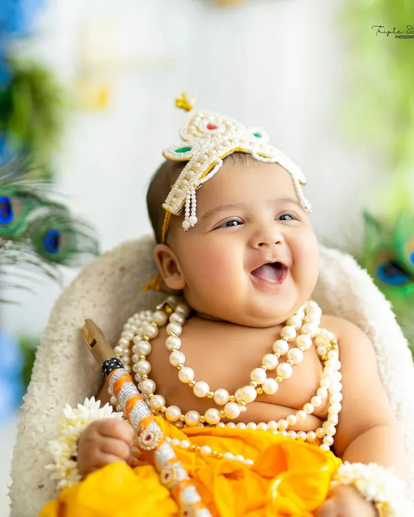 The most joyful, heartwarming smile from a baby Krishna. This close-up captures the pure happiness and divine charm of our festive Janmashtami sessions.