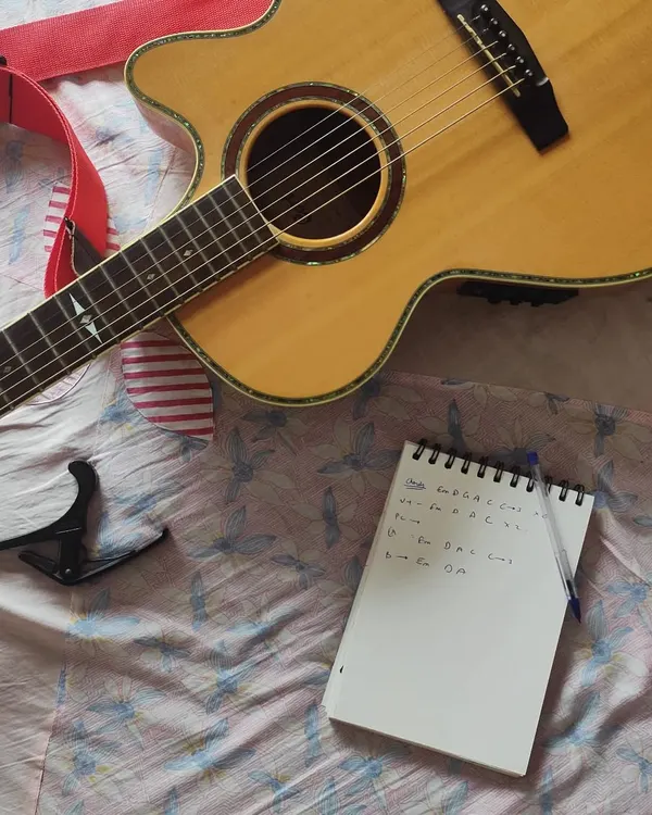 It all begins with your story. I take the details you give me and start mapping out the song's structure, chords, and lyrics in my notebook. This is the blueprint for your custom piece.