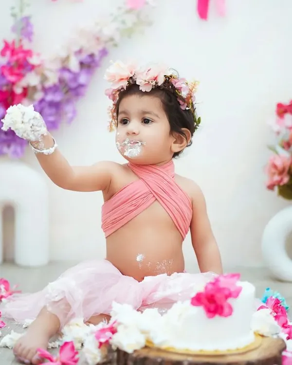 This is what a first birthday is all about! This little girl is enjoying every bit of her cake smash, and I'm here to capture all the messy fun.