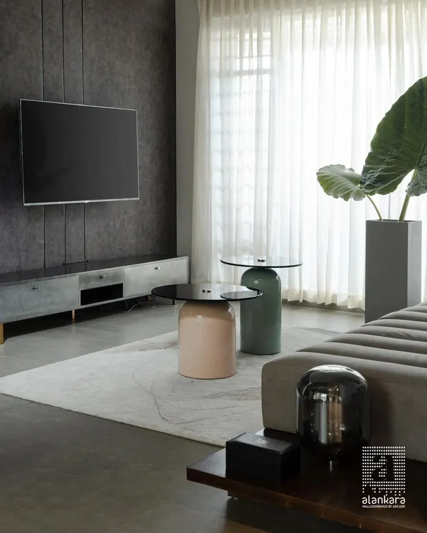 This living area is a study in modern sophistication. I paired a sleek, low-profile media unit with uniquely shaped ceramic coffee tables to create a focal point that is both artistic and functional. The sheer curtains soften the space, allowing for a gentle diffusion of light.