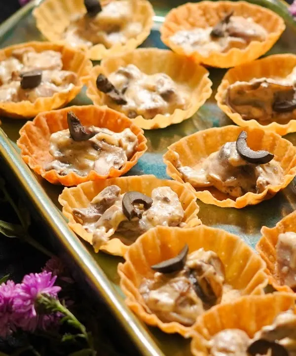My Creamy Mushroom Tarts are a vegetarian delight. A rich, savory mushroom filling is served in a crispy tart shell and topped with an olive for a touch of saltiness.