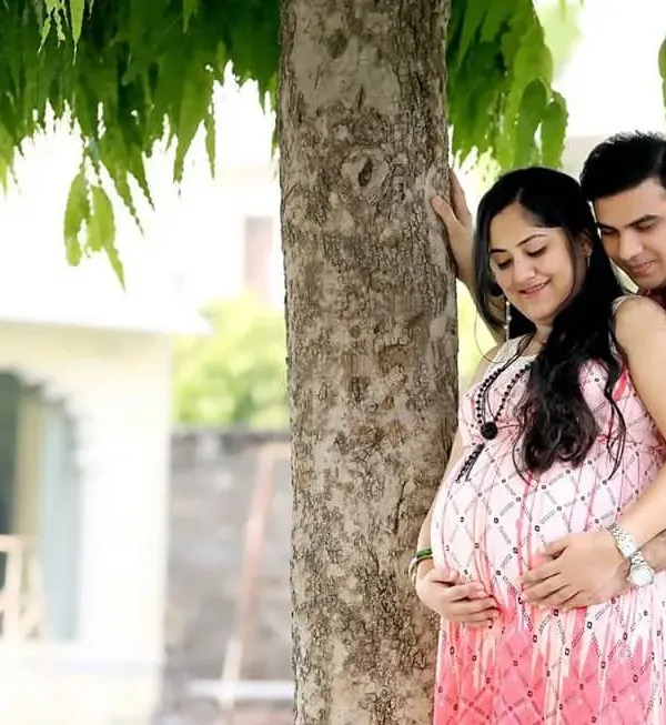 An intimate moment between an expecting couple during their outdoor maternity shoot. We guide you into natural poses that show your connection and excitement.