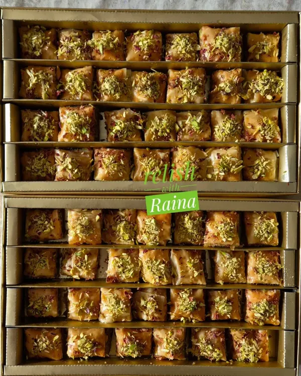 Two boxes of my square-cut Baklava, ready for a customer. This sweet is perfect for gifting or for treating yourself, with its nutty aroma and crisp texture.