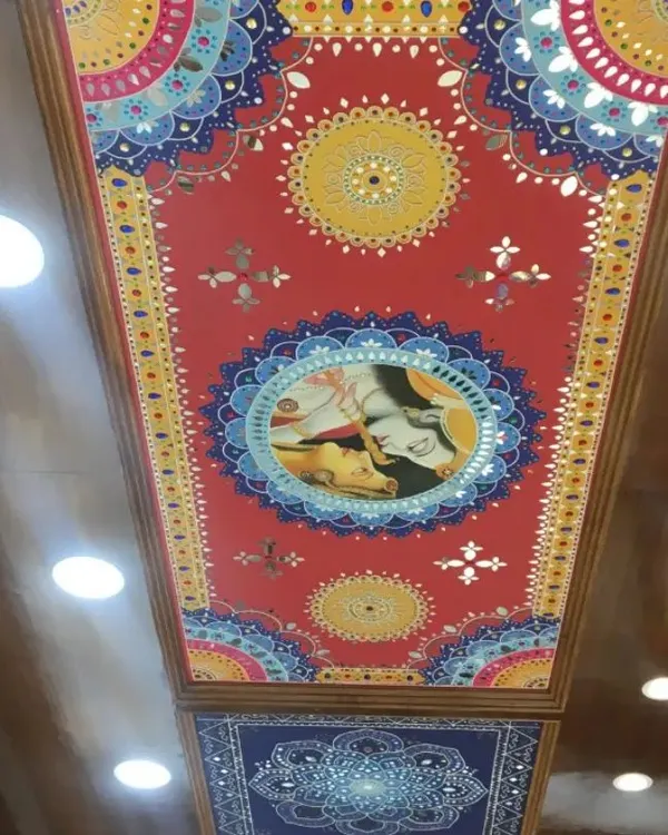 This custom Radha-Krishna Lippan art panel was designed and installed as a ceiling centerpiece. The vibrant colors and detailed mirror work create a stunning focal point, demonstrating how we can transform a simple ceiling into a work of art for your home.