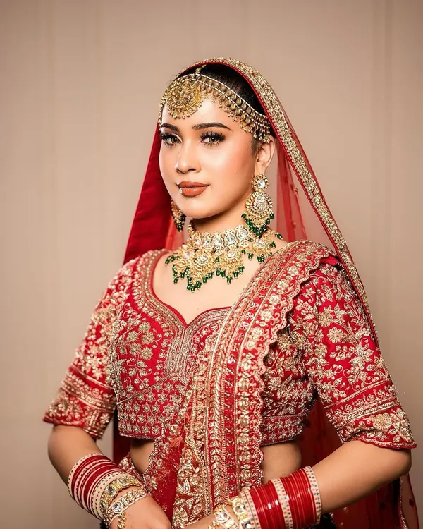 A classic bridal portrait showcasing a traditional red lehenga with our signature makeup. We focused on defined eyes and a balanced complexion to complement the rich tones of the outfit and heavy jewelry.