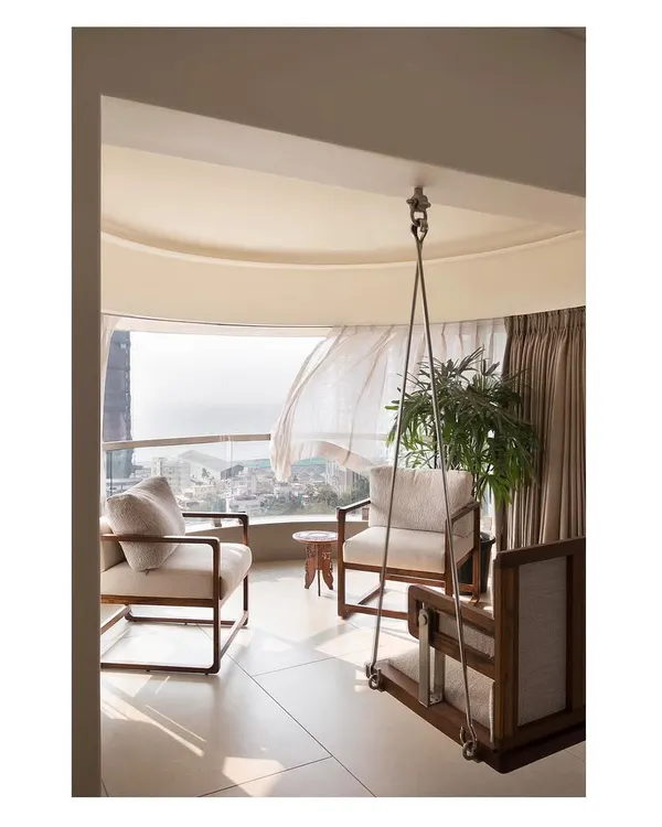 The highlight of this Mumbai apartment is the bay window seating area, complete with a custom swing. It’s a perfect example of how we create spaces that connect with the outdoors and provide moments of peace.