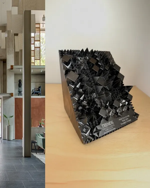 We are proud to be the recipients of the 'Practice of the Year 2024' award from Trends Excellence. This image pairs the trophy with a view of our Magari showroom interior, a project that embodies our design ethos.