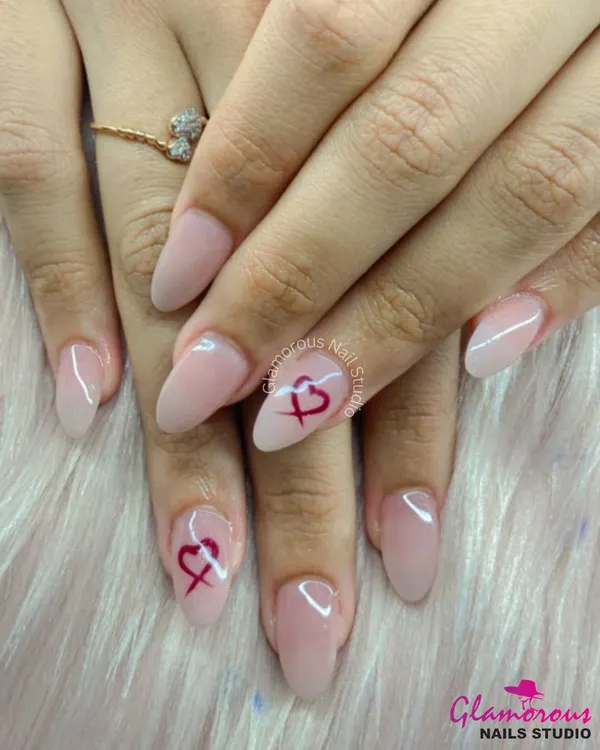 Sometimes, less is more. This beautiful set features a clean, semi-sheer nude base on a classic almond shape, with a single, delicately painted heart on the accent nails. It's the definition of simple and sweet.