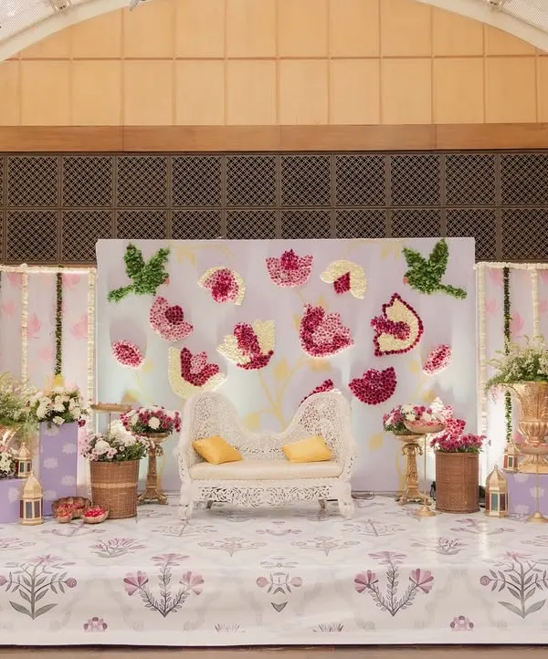 The full stage for a beautiful Godh Bharai, or traditional baby shower. We used a lotus theme with floral art, traditional brass vases, and a custom printed floor.