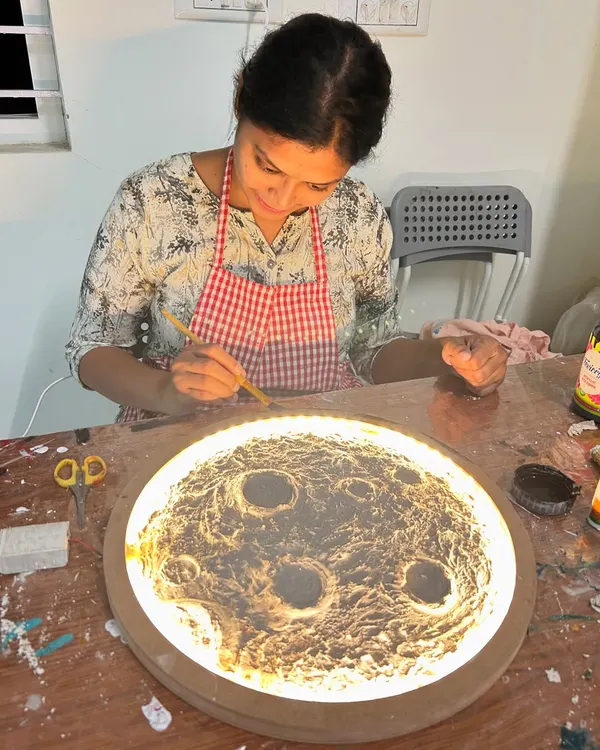 Our moon lamp workshop is a truly unique experience. A guest is seen here adding texture and paint to create a realistic moon surface that glows beautifully.