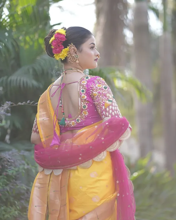 This is the classic Maharashtrian bridal bun, my specialty. I meticulously craft the bun to be neat and secure, providing the perfect base for fresh flowers and traditional hair jewelry. This style is designed to hold perfectly throughout a long day of ceremonies.