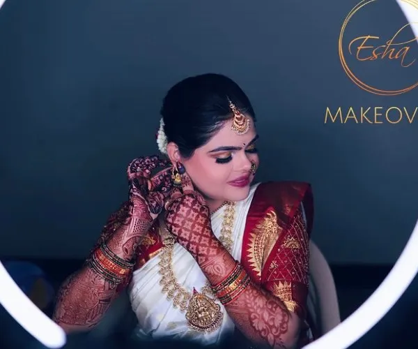 A classic South Indian muhurtham look, featuring a flawless base that glows under the lights, intricately defined eyes, and traditional temple jewellery. This look is all about timeless elegance.