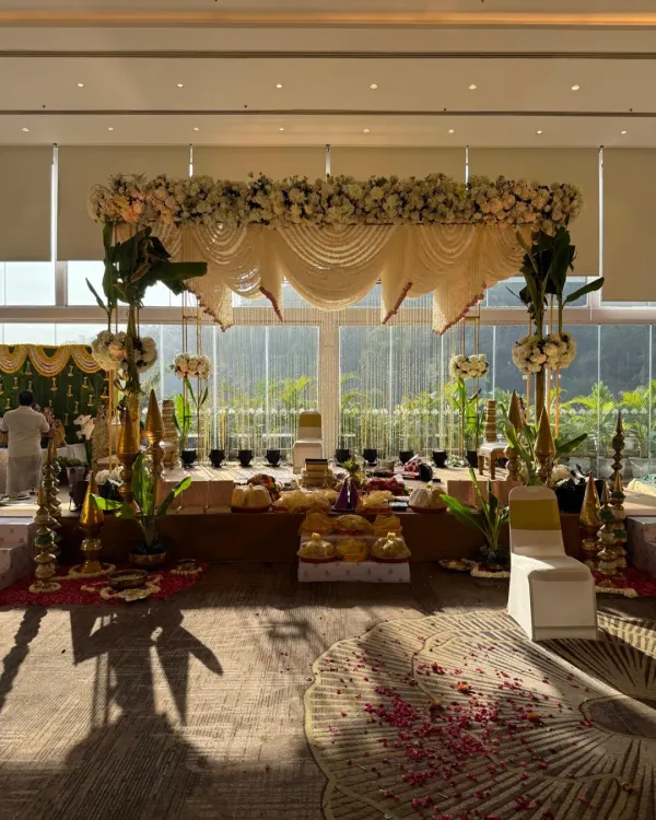 A classic South Indian wedding mandap, bathed in natural morning light. We used traditional elements like banana leaf pillars and garlands of white tuberoses to create a serene and sacred space for the ceremony.