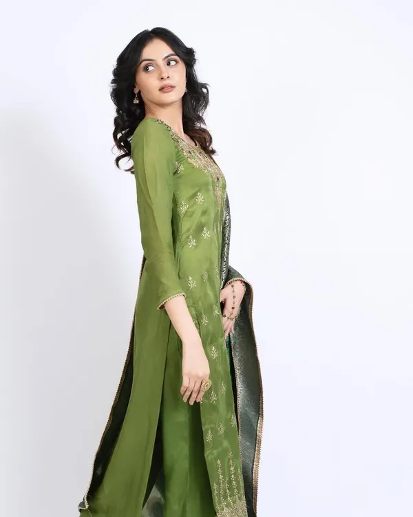 A test shoot featuring a model in an elegant green ethnic suit. The makeup is dewy and minimal, with soft curls in her hair to create a fresh and sophisticated look.