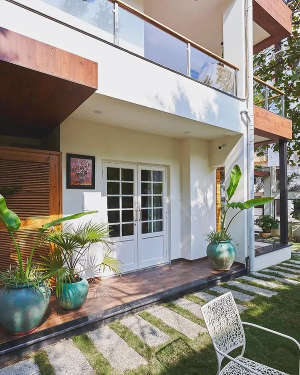 A client's beautiful home, where my antique sea green 'Nusa' and 'Lumpur' terracotta planters add a touch of plush earthiness to their modern outdoor space.