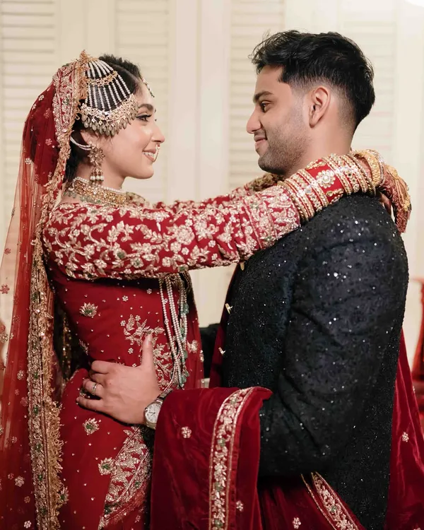 A beautiful moment of connection between the bride and groom after their Nikaah. The bride's arms wrapped around her husband shows a lovely, intimate connection.