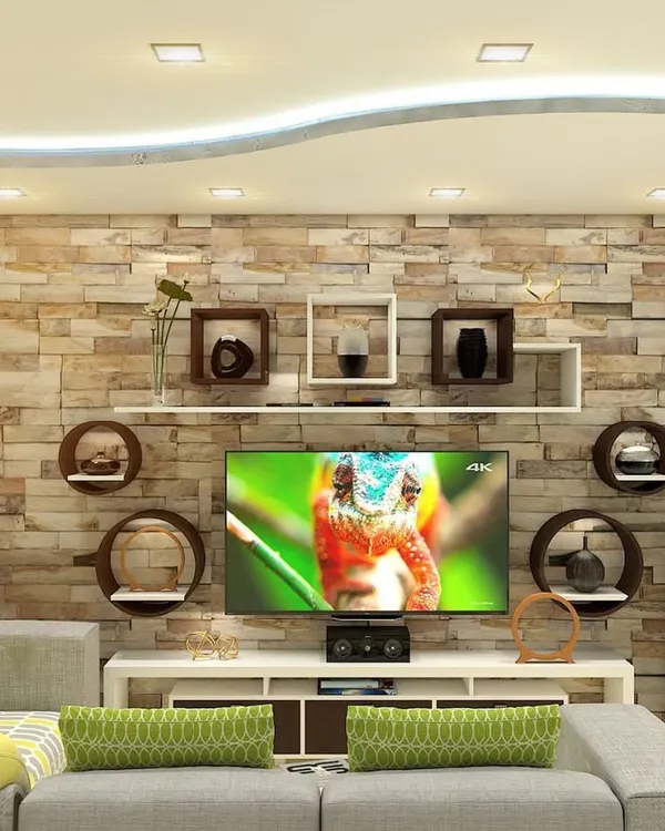 A living room centered around a custom entertainment unit set against a stone-cladding accent wall. The design includes a variety of circular and rectangular floating shelves for a unique display.