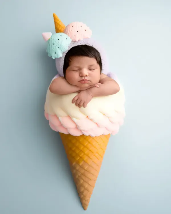 Sweet as can be! This newborn is dressed as a scoop of ice cream in this fun, creative, and completely safe composite image.