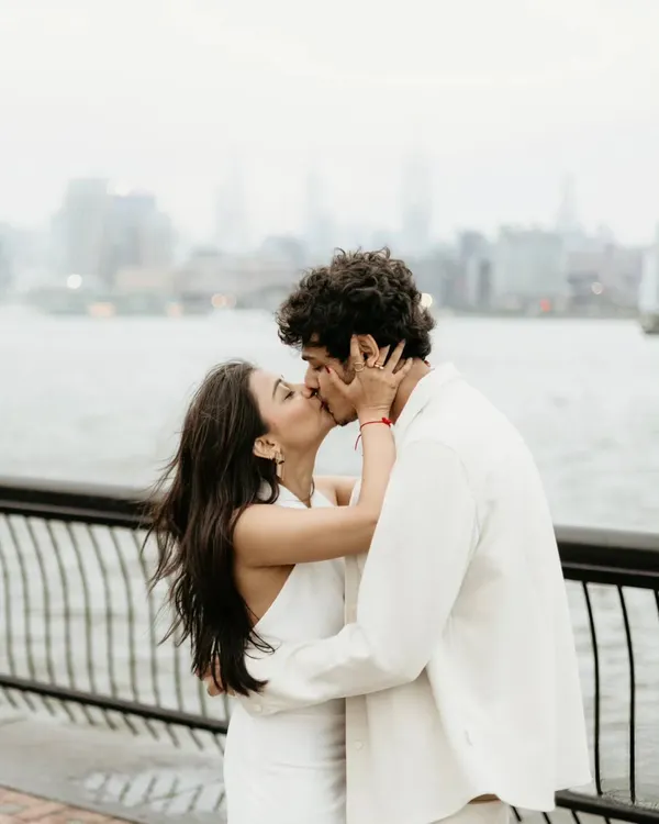 An intimate kiss with the New York City skyline softly blurred in the background. This destination pre-wedding photo focuses on the couple's connection while still capturing the essence of the city.