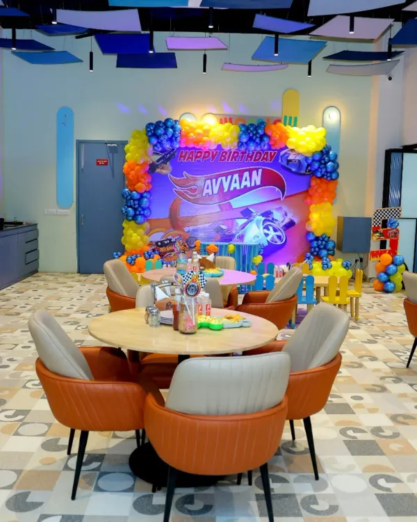 A 'Hot Wheels' themed birthday party in full swing! We transformed our cafe area with custom banners, balloon arrangements, and table settings to create an immersive racing world for the birthday boy.